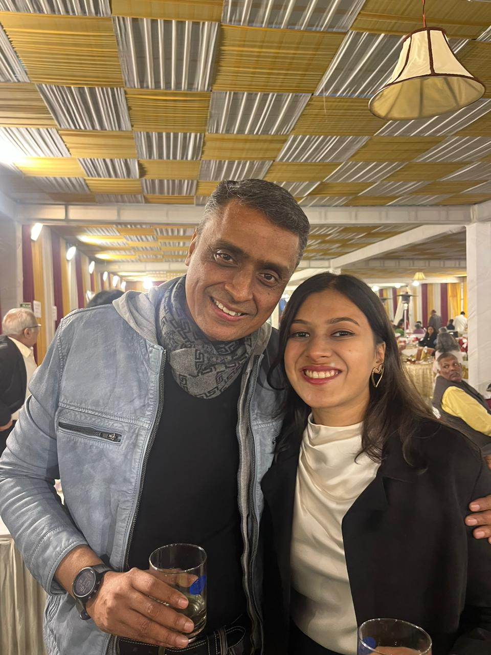 Dr. Anshul Gupta with his daughter Aarushi, the two smiling together at a gathering.